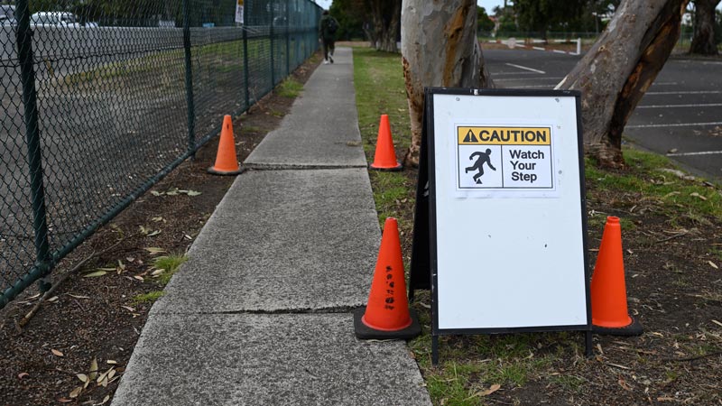 Raised concrete cracks in a sidewalk